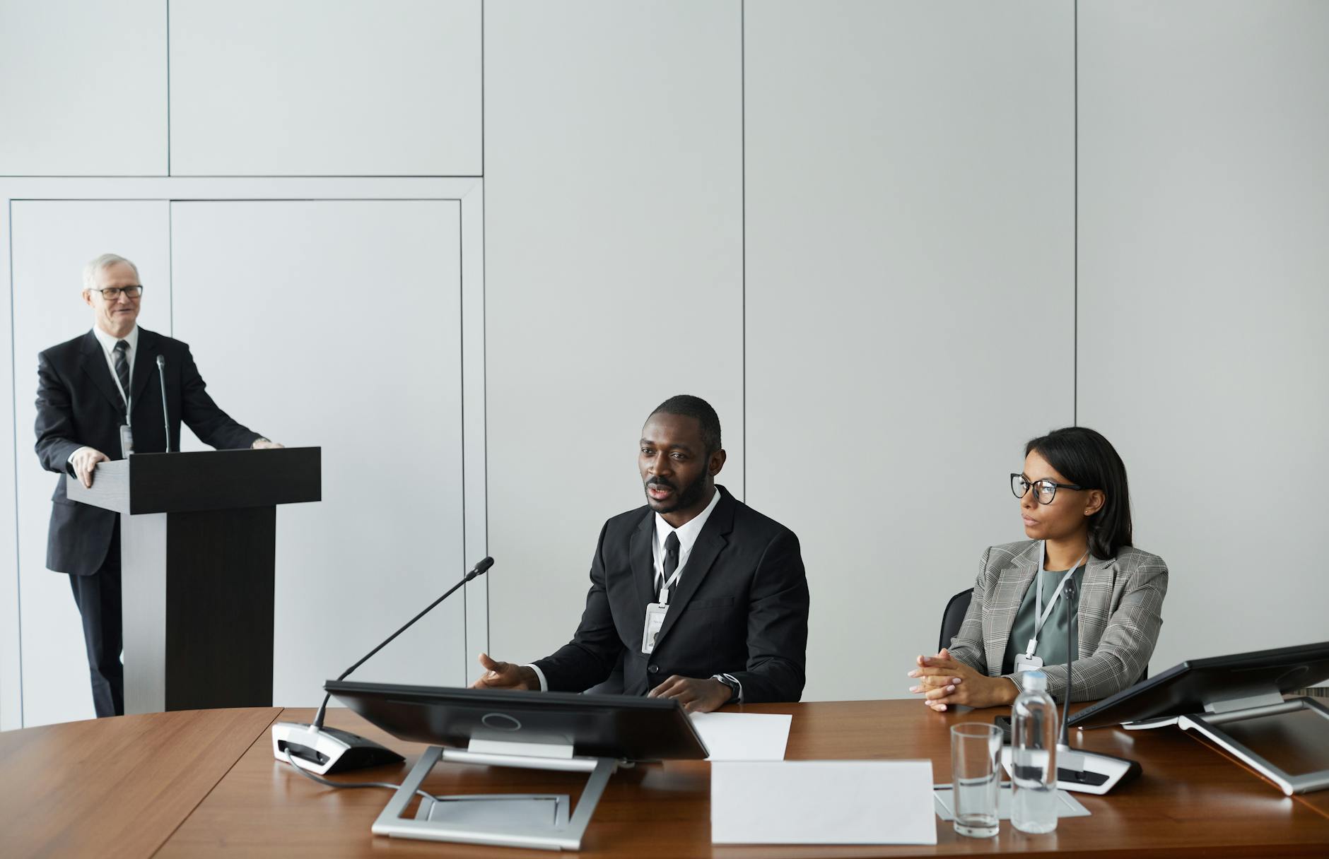 Professionals discussing AI ethics and regulatory frameworks in a conference