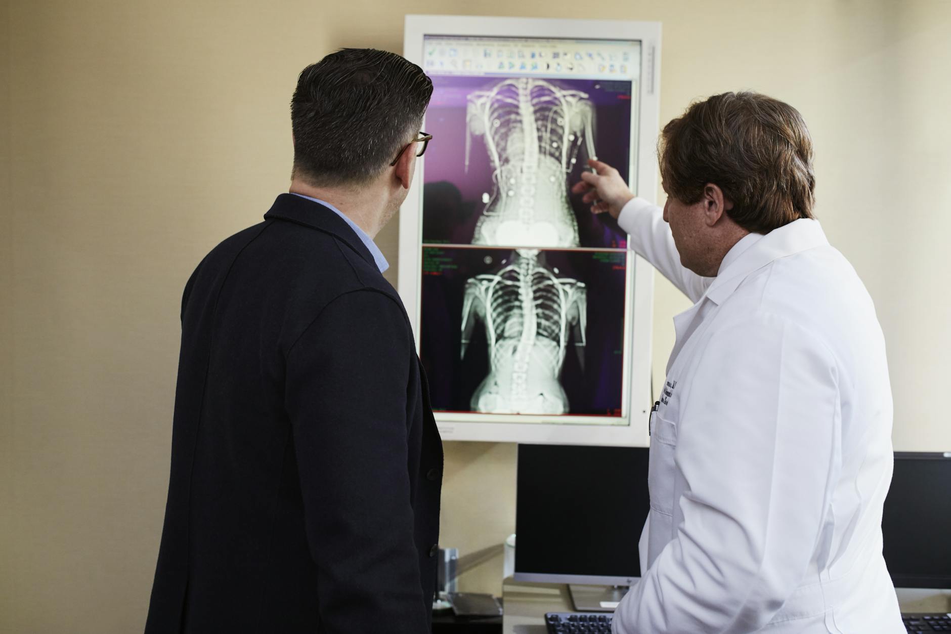 A doctor and patient interacting with a futuristic AI-powered diagnostic interface.