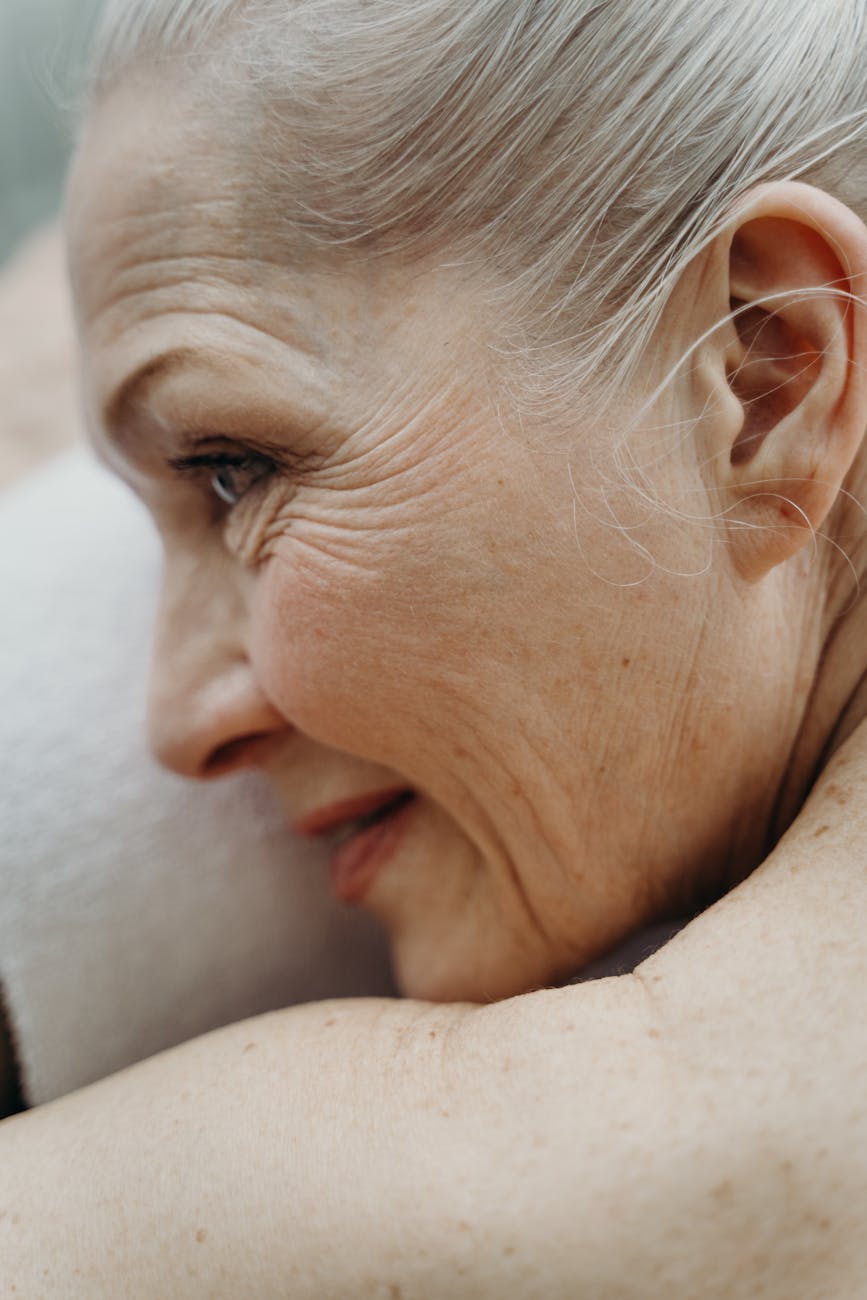 A split image showing a healthy, vibrant elderly person on one side and a representation of cellular decay on the other, with a gene editing tool bridging the gap.