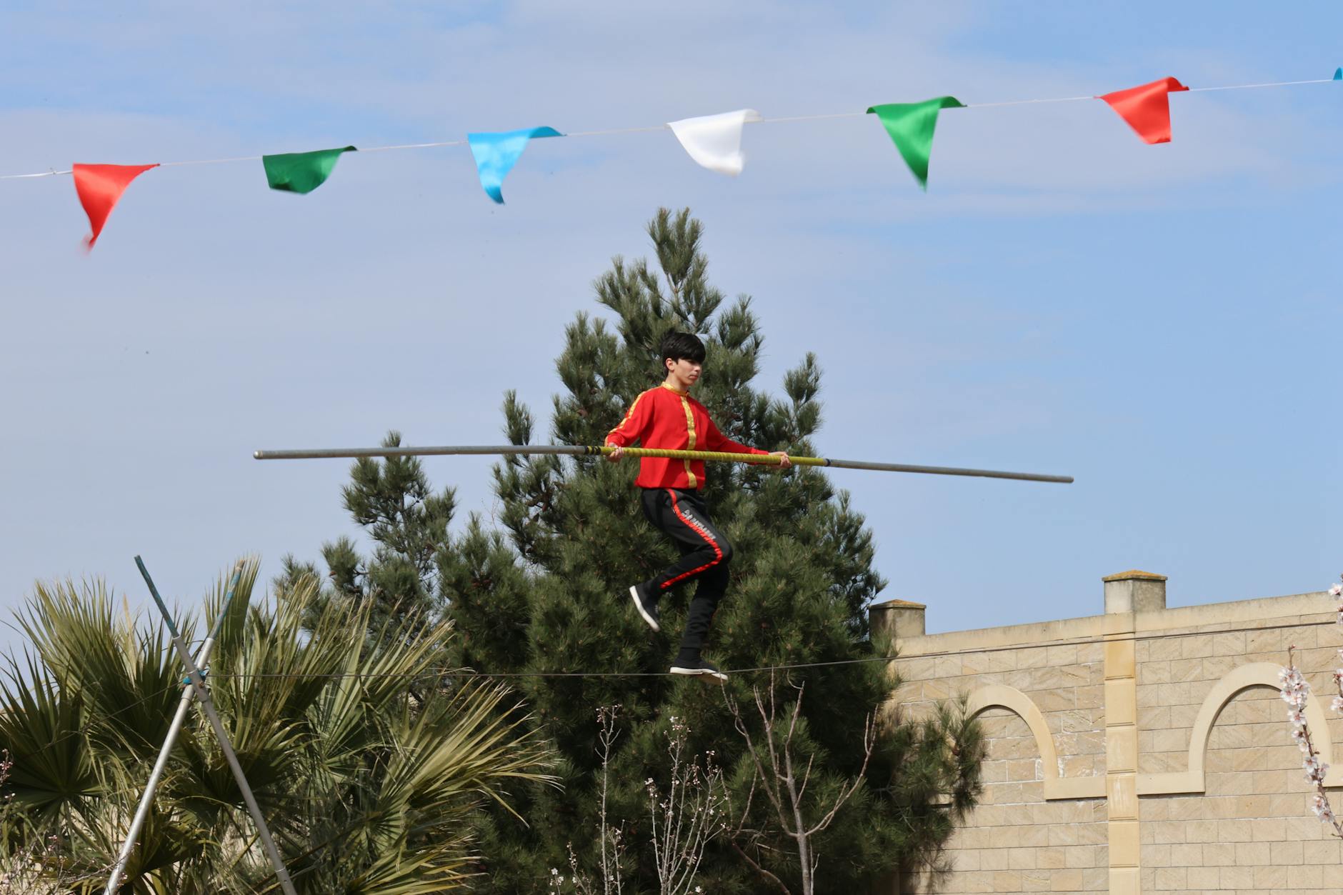 A symbolic image of a tightrope walker balancing precariously over a chasm, representing the delicate and dangerous path of germline gene editing.