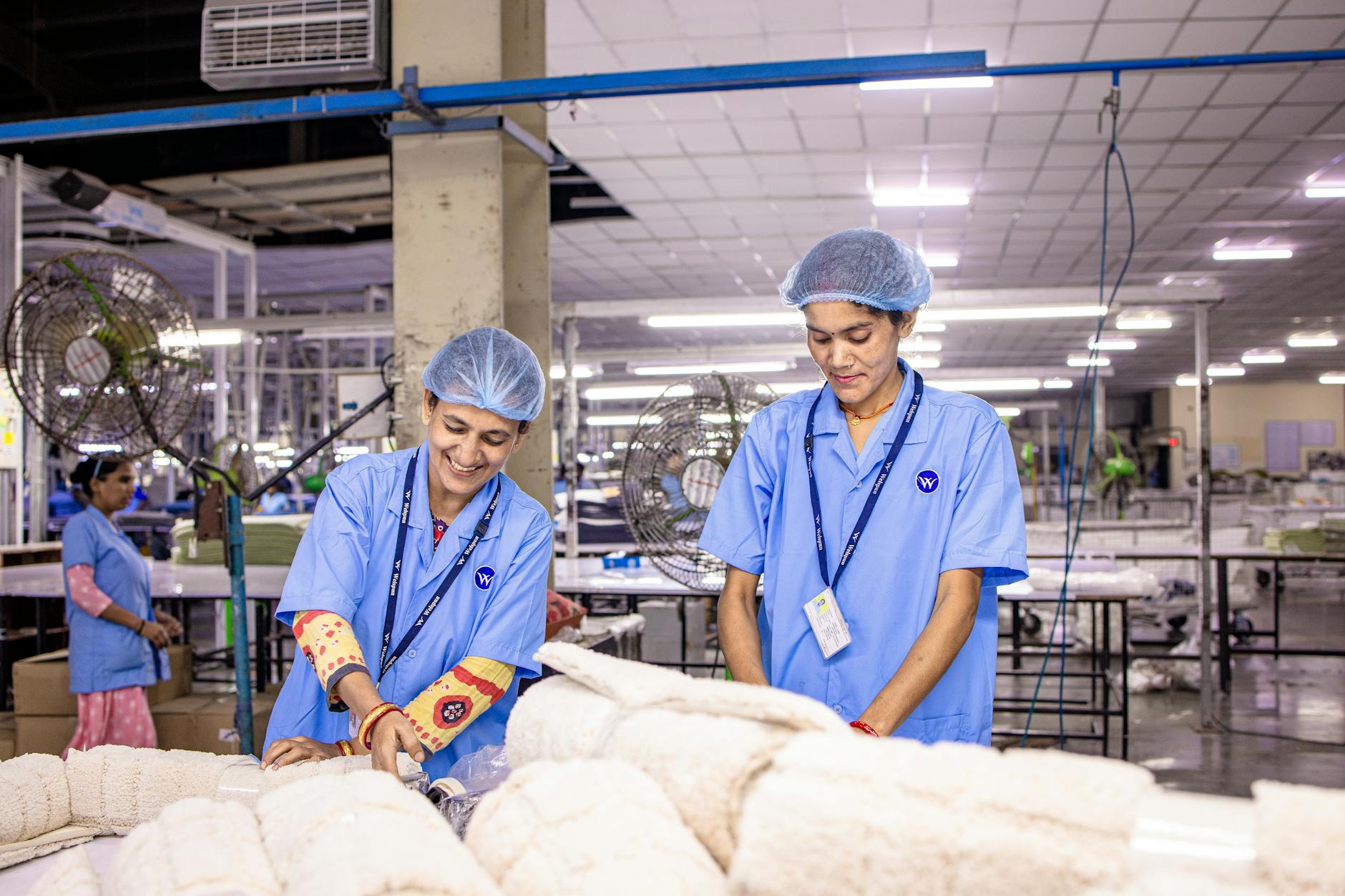 A humanoid robot working alongside human workers in a manufacturing line