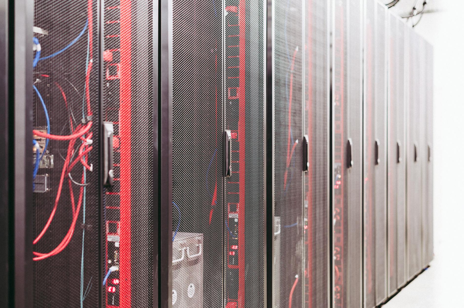 A high-angle view of a sleek, minimalist cloud data center, bathed in ethereal blue light, with abstract data streams flowing, representing the foundational infrastructure for cloud robotics.