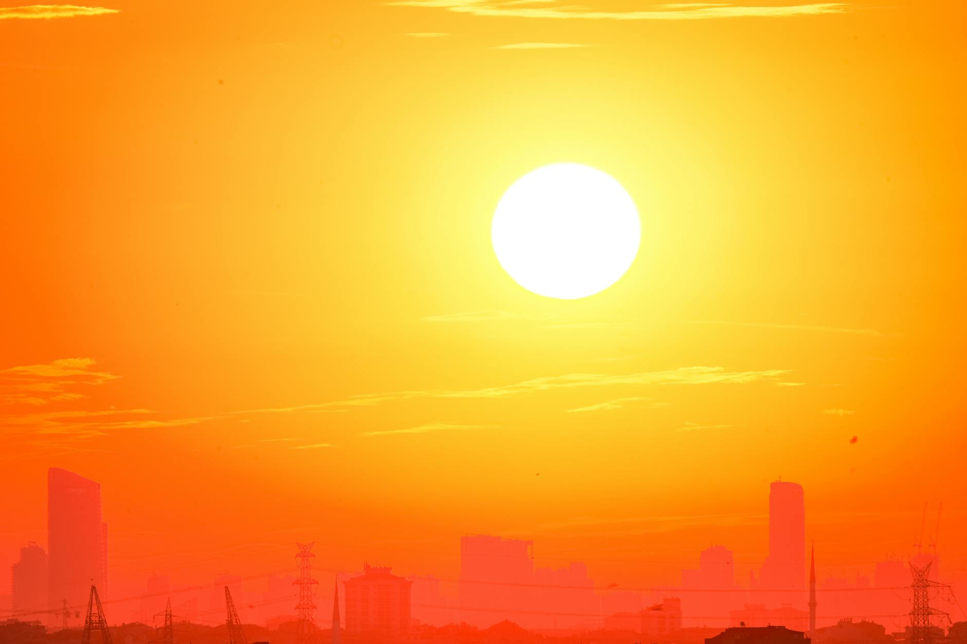 A symbolic image of a stylized sun emitting powerful beams of energy towards Earth, with a silhouette of a futuristic city powered by clean energy in the foreground. The overall mood is optimistic and forward-looking.