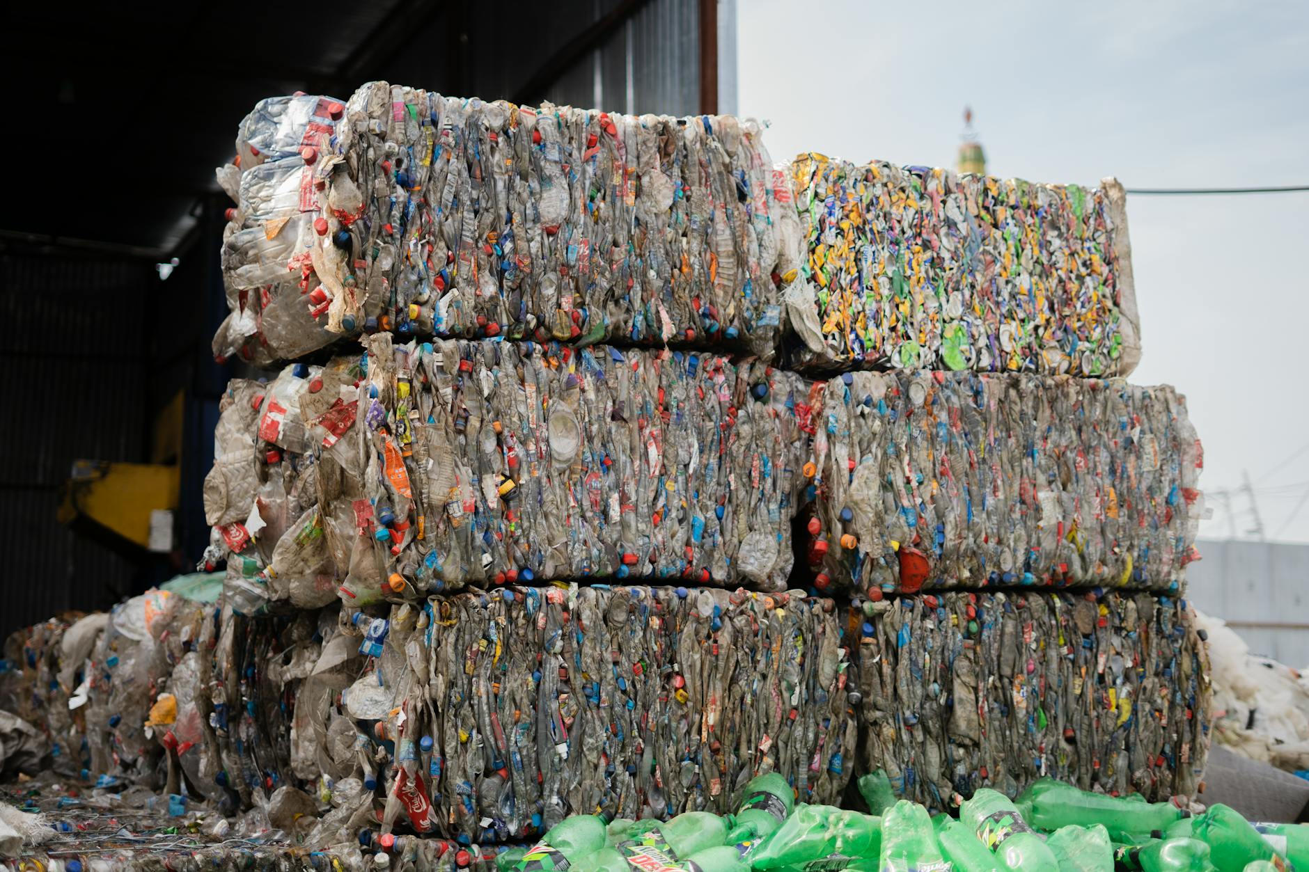 A split image showing plastic waste being transformed into new materials and a modular hydrogen production unit in operation.