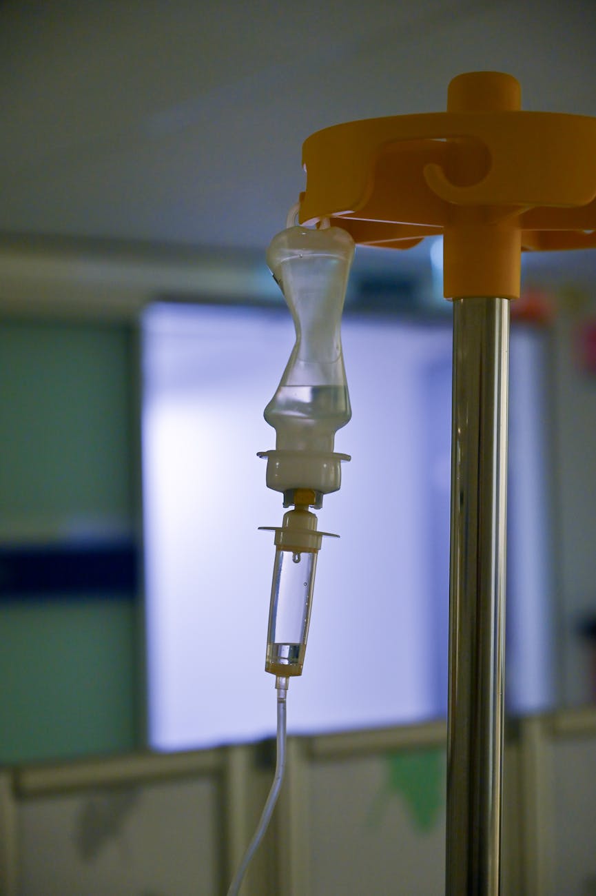 A split image showing a patient receiving a gene therapy infusion on one side, and a microscopic view of corrected cells on the other, representing the clinical application and biological impact of CRISPR therapies.