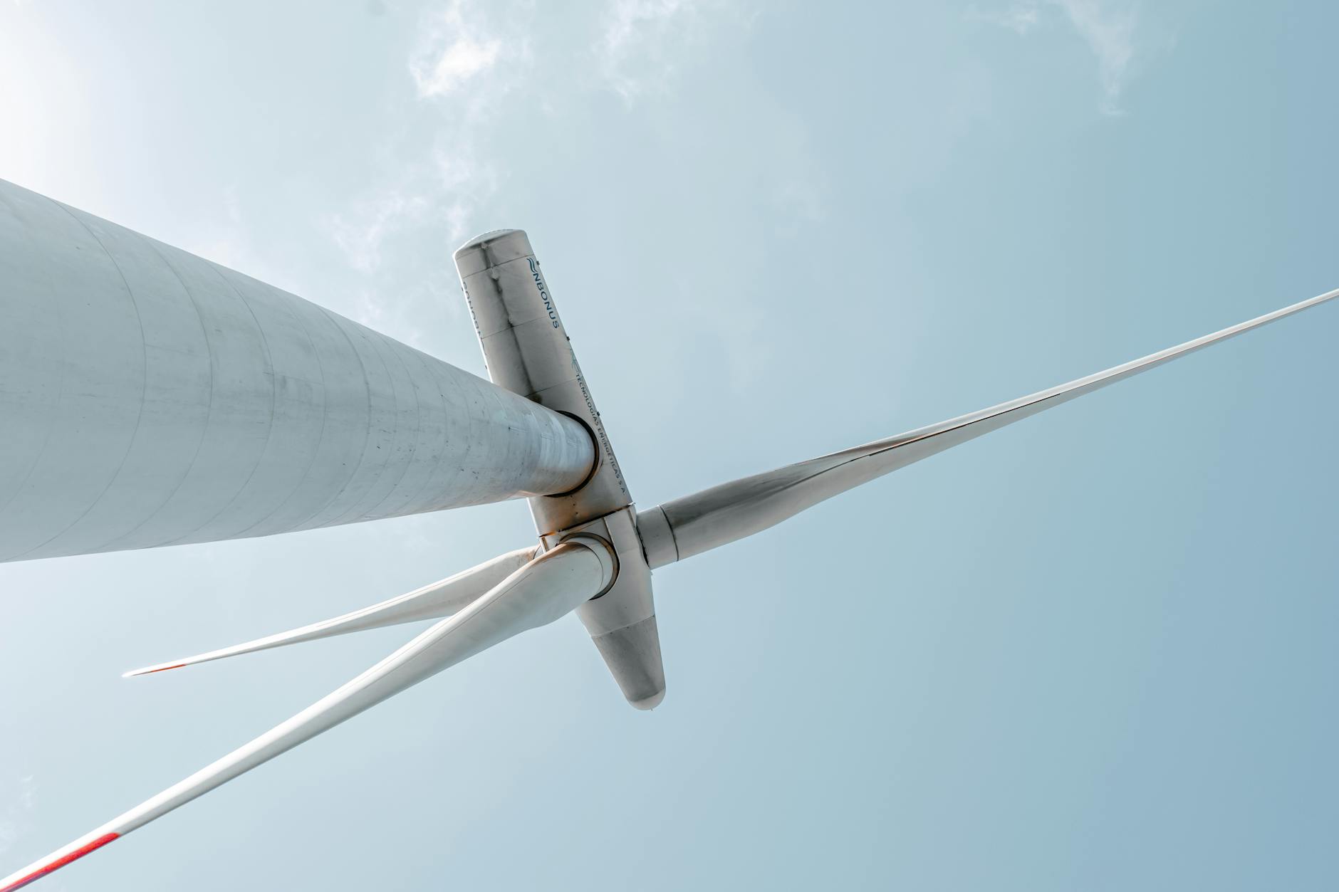 A split view showing a physical power plant turbine and its corresponding, detailed digital twin, with predictive maintenance alerts highlighted.