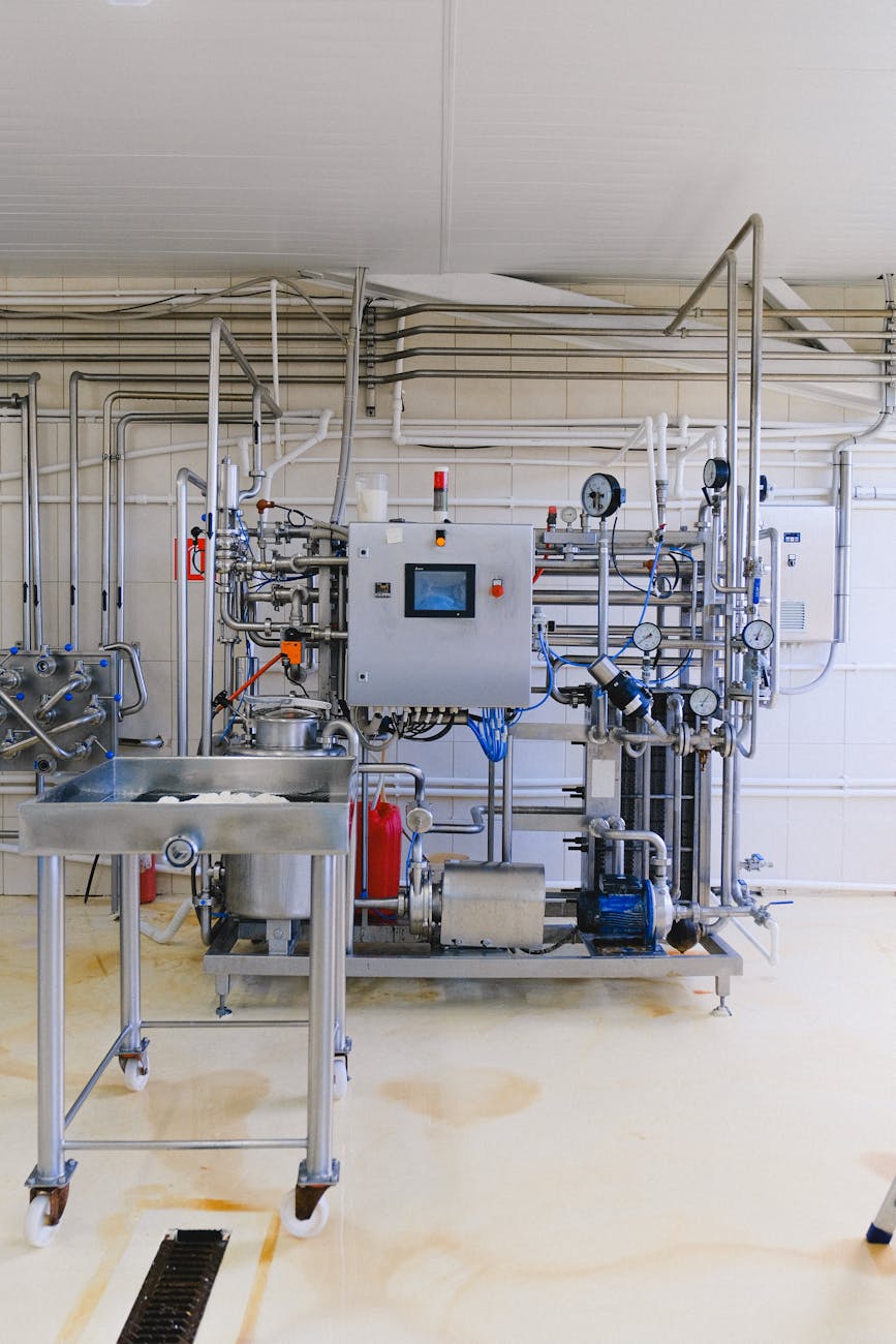 A split view, one side showing a traditional factory floor with manual controls, the other side a sleek, automated control room with holographic displays.