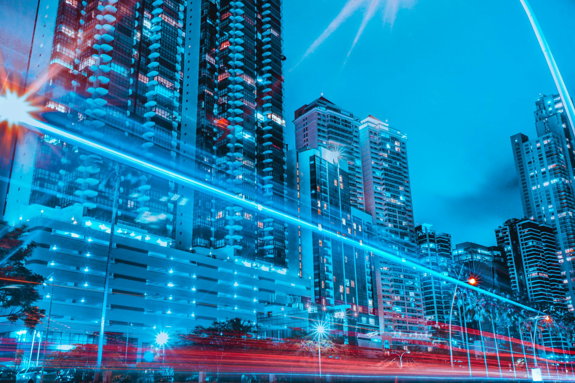 A conceptual rendering of a futuristic urban skyline at dusk, with sleek, electric vertical take-off and landing (eVTOL) aircraft gracefully navigating between illuminated skyscrapers towards a modern vertiport, evoking advanced technology and environmental harmony.