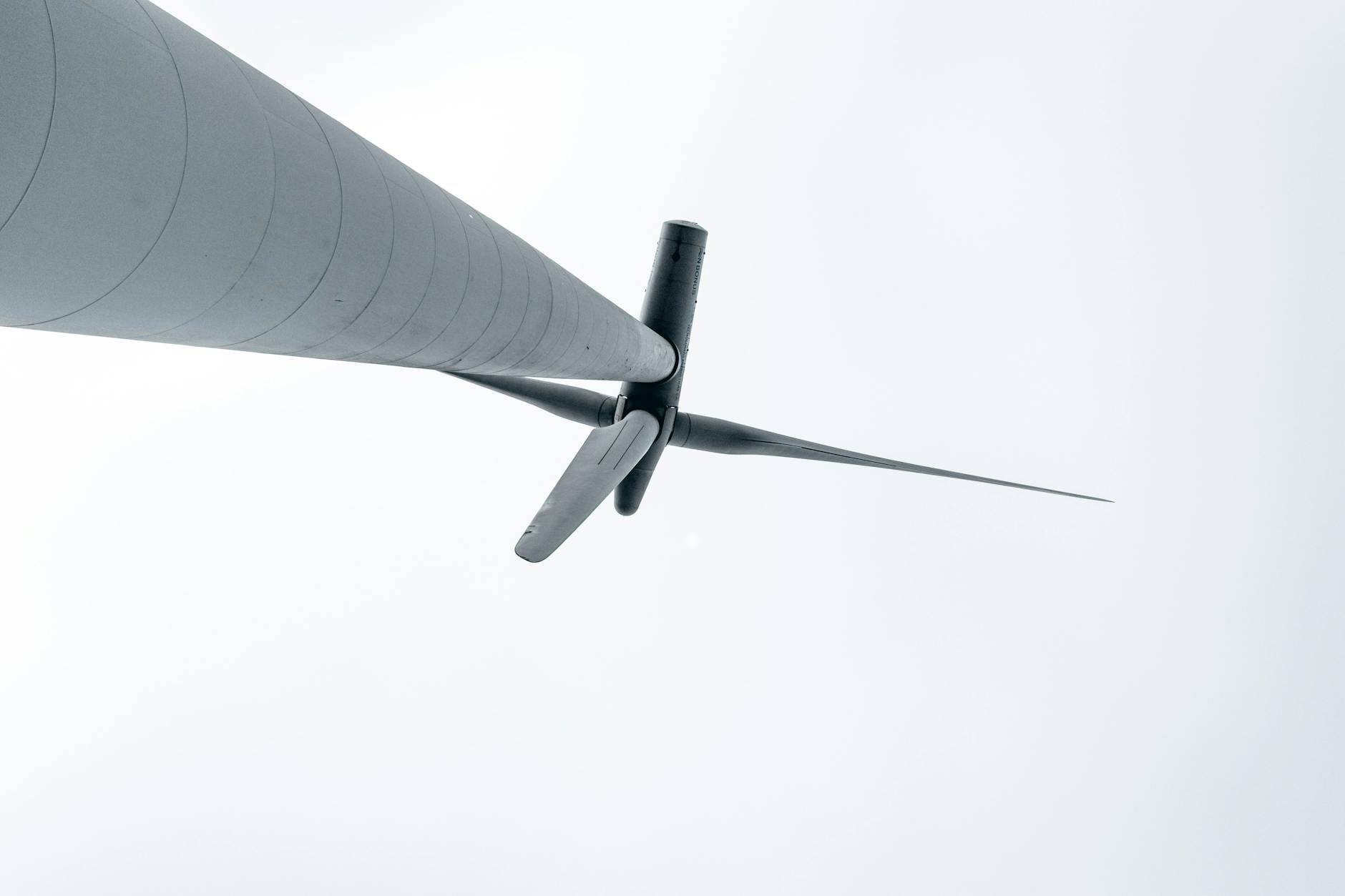 A split image showing a physical wind turbine on one side and its corresponding digital twin with performance data overlays on the other.