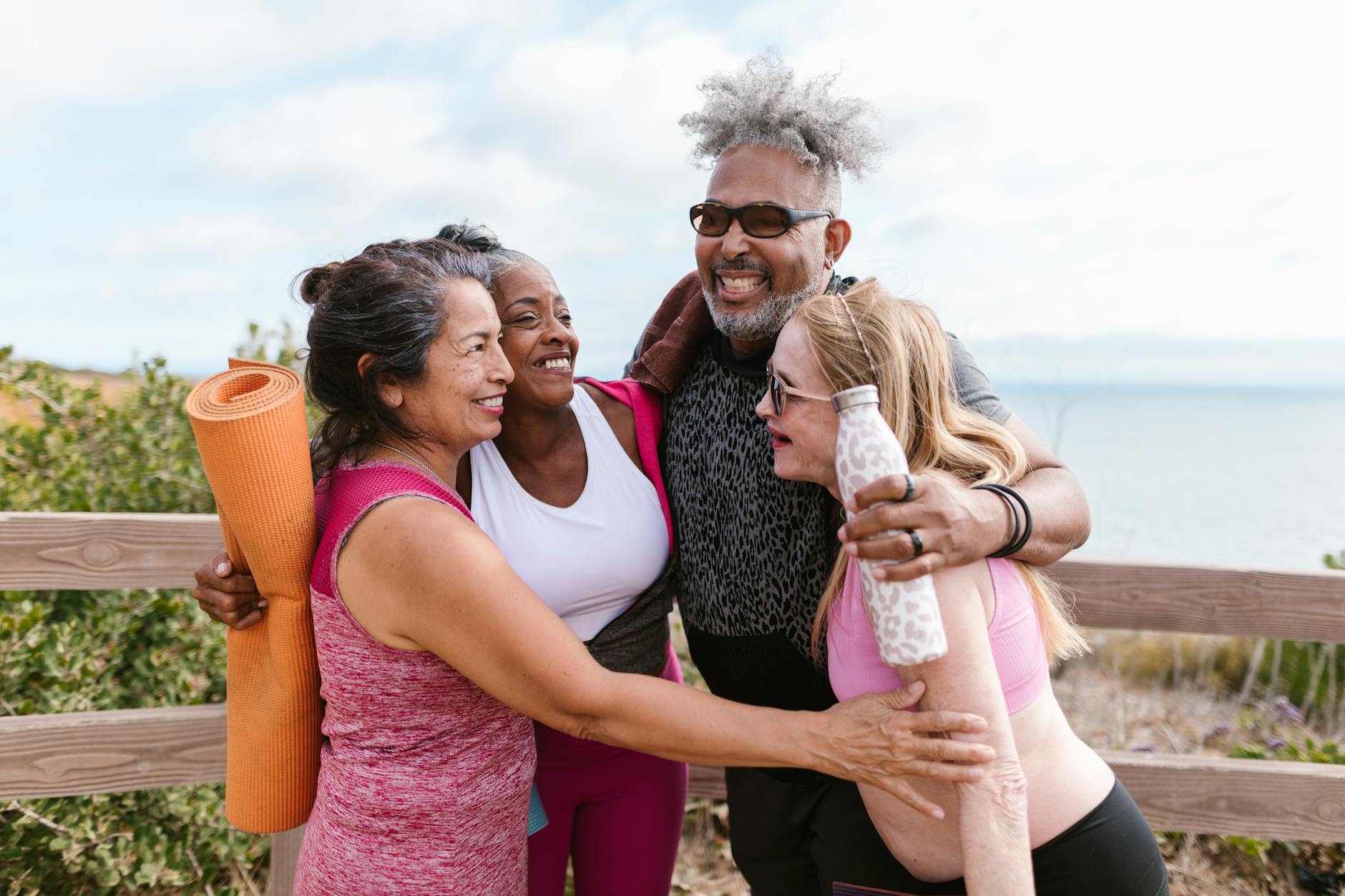 A diverse group of healthy, active elderly individuals enjoying life in a vibrant, futuristic city park.