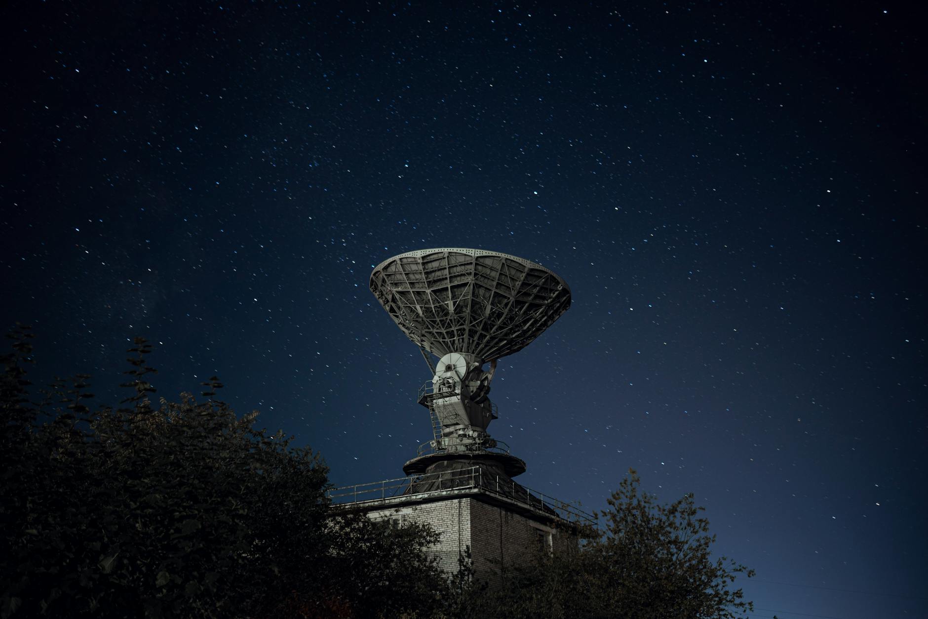 A futuristic, sleek satellite equipped with advanced quantum antennae, orbiting Earth against a backdrop of stars and nebulae. The image should convey a sense of cutting-edge technology and vastness.