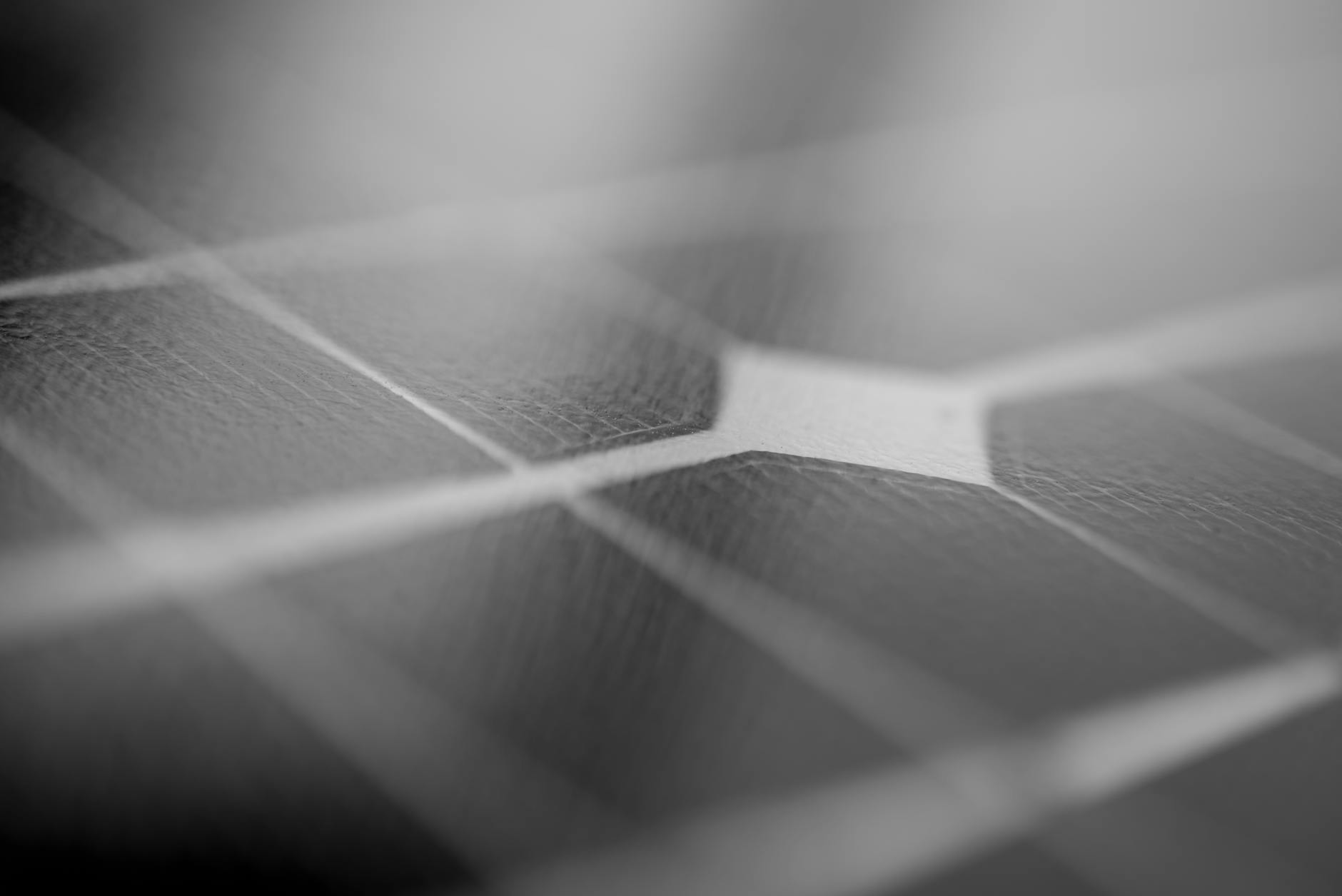 A futuristic artist's rendition of a massive solar power satellite in geosynchronous orbit, beaming energy towards Earth with a visible, focused beam.