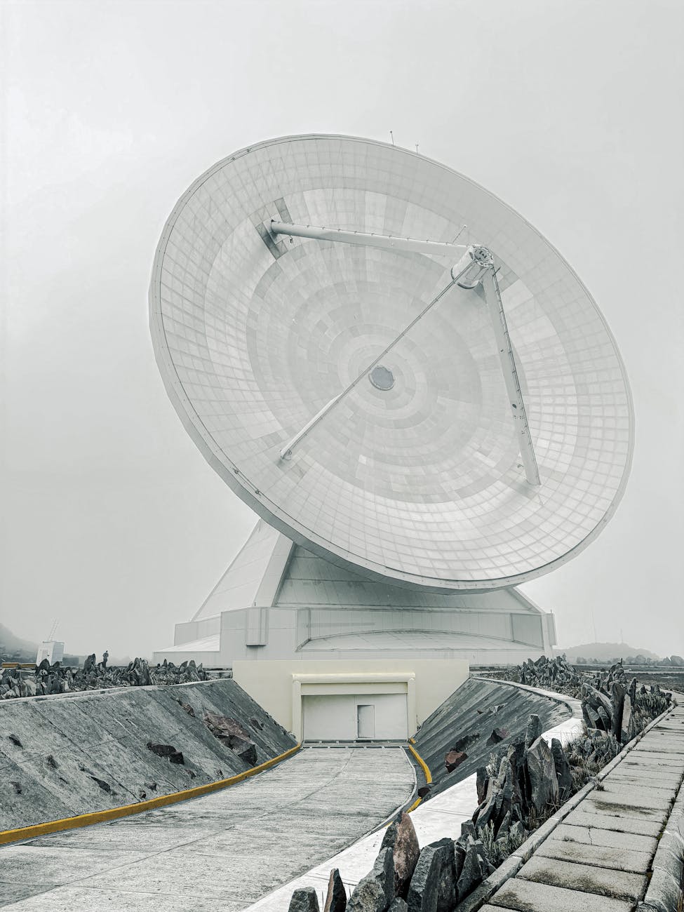 A split image showing two different conceptual designs of SBSP satellites – one modular and one large, monolithic – highlighting diverse engineering approaches.