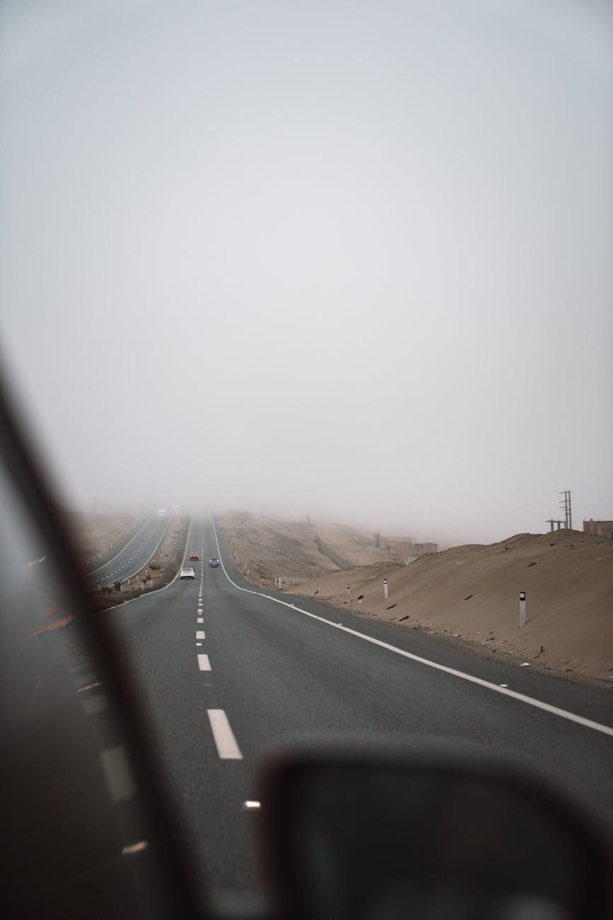 A symbolic image of a road stretching towards a distant, futuristic city skyline, with an autonomous vehicle at the forefront, representing the journey and destination of Level 5 autonomy.