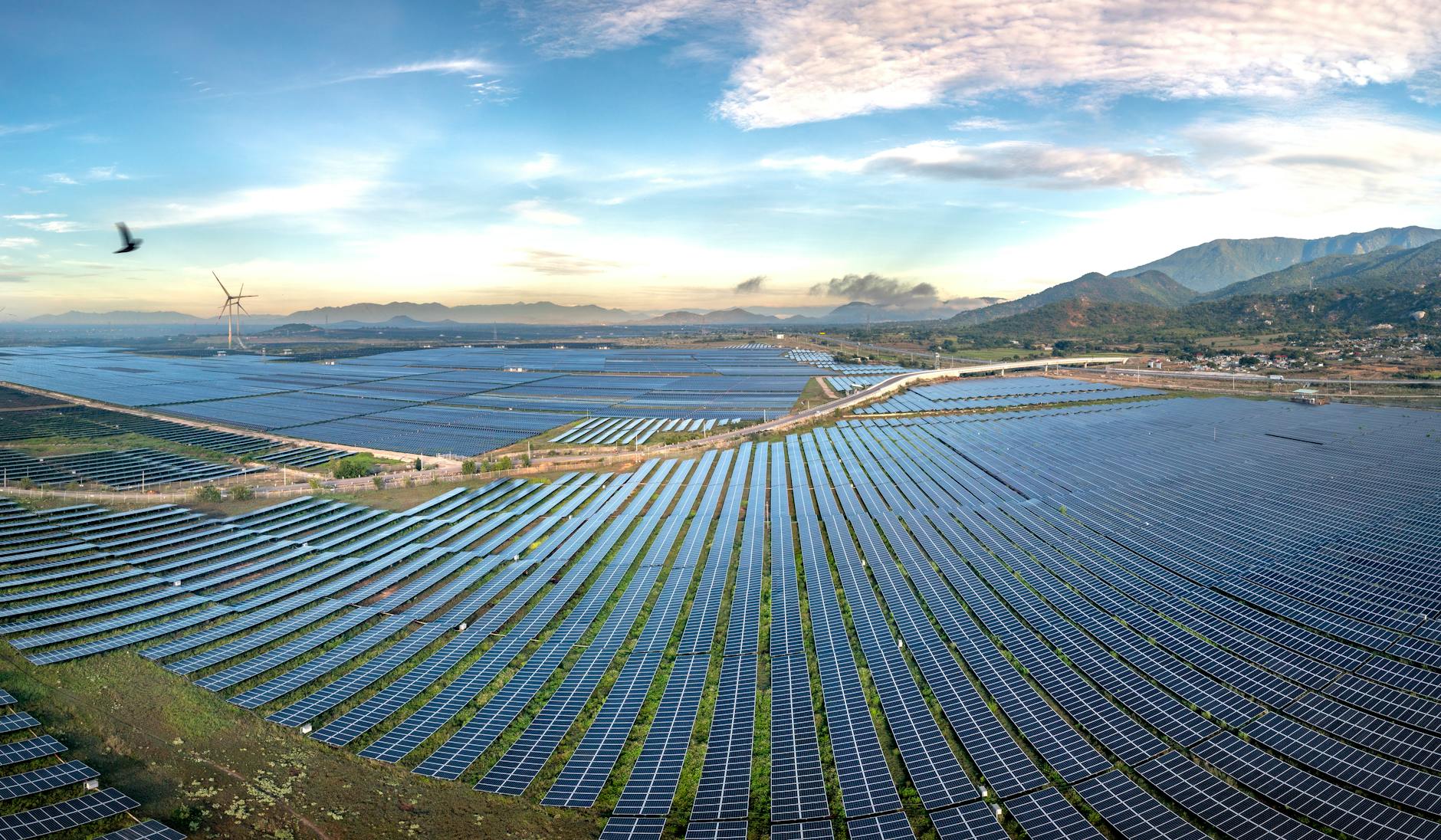 A breathtaking, panoramic shot of a future city skyline powered entirely by renewable energy, with prominent LDES facilities seamlessly integrated into the landscape, bathed in the warm glow of a sunrise, symbolizing a new era.