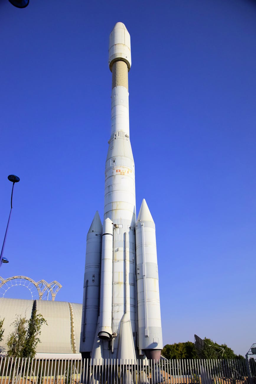 A panoramic view of a bustling, futuristic spaceport with multiple spacecraft docked, some featuring quantum-powered propulsion systems, hinting at advanced capabilities. The sky above is filled with orbital platforms. Detailed explanation: A futuristic spaceport demonstrating advanced space travel enabled by quantum technologies.