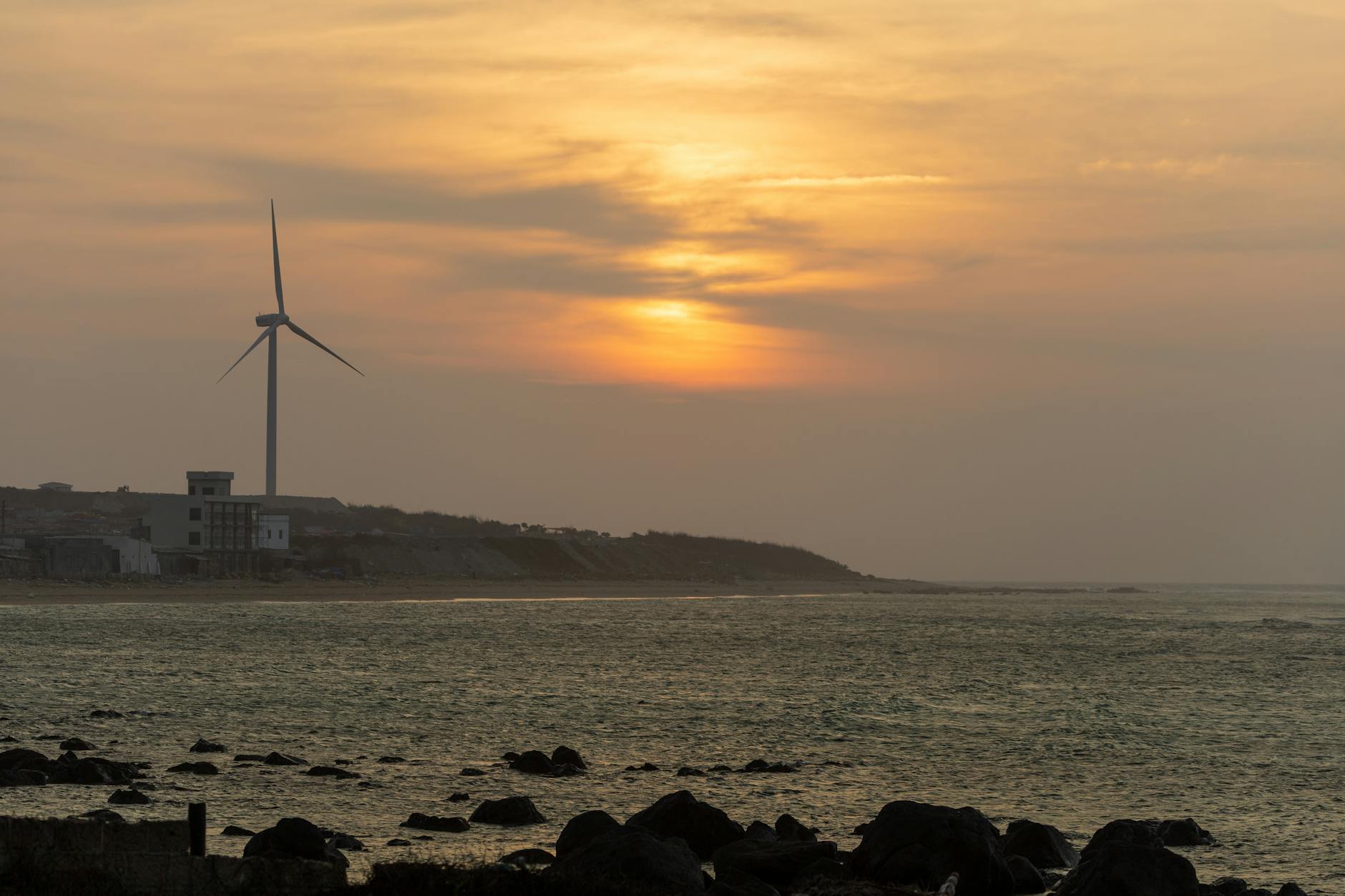 A futuristic, serene landscape with towering wind turbines and solar arrays seamlessly integrated, with a network of glowing blue hydrogen pipelines snaking across the terrain towards a gleaming industrial complex.