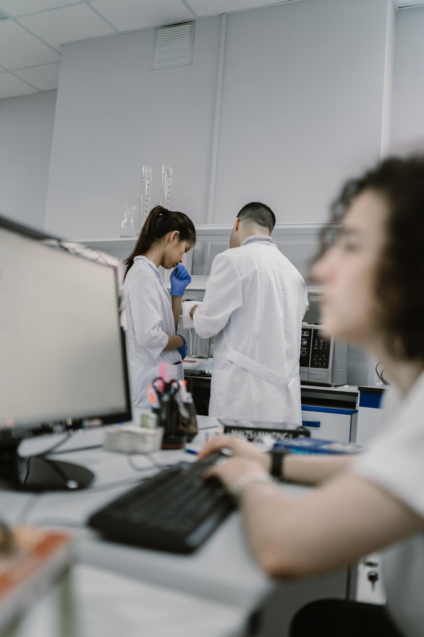 A sleek, modern research facility, bathed in soft, futuristic lighting. Scientists in lab coats are collaborating around holographic displays, showcasing 3D models of micro-robots and complex AI algorithms. The atmosphere is one of intense innovation and intellectual synergy.