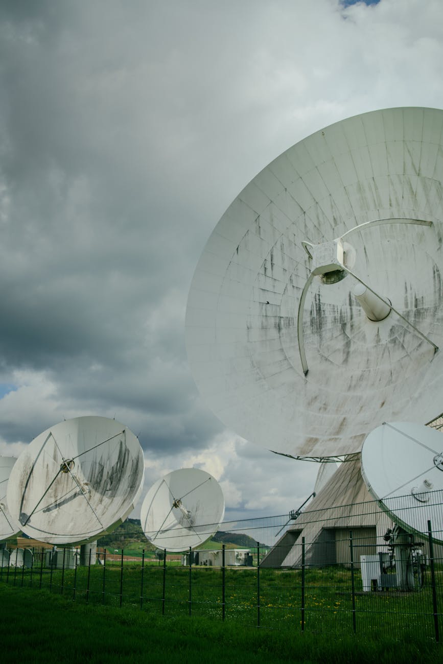 A constellation of advanced AI-powered satellites orbiting Earth, interconnected by glowing data lines, with detailed real-time Earth observation data streaming to ground control centers.