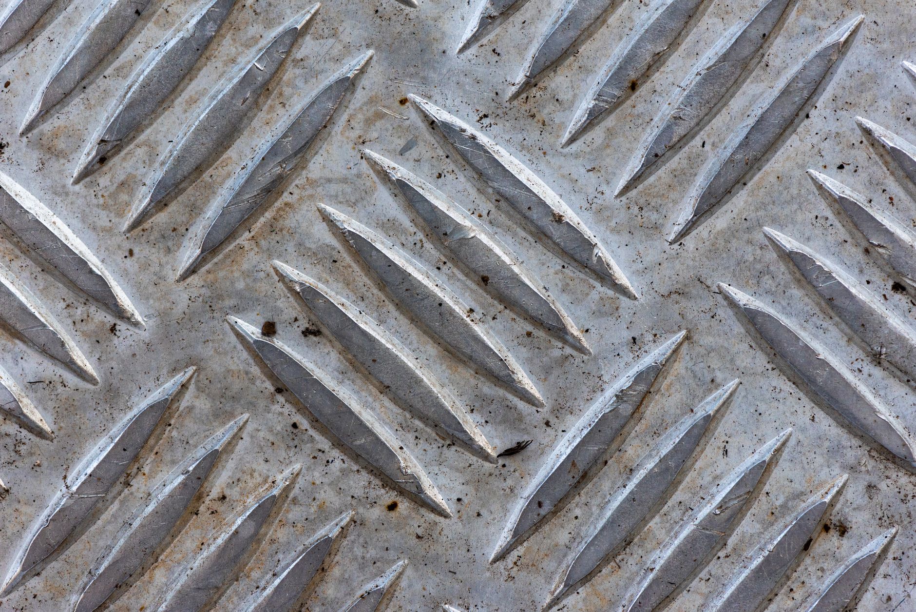 A microscopic view of advanced, neutron-resistant material surfaces, showing a pristine, resilient lattice structure, under an intense, simulated energy bombardment.