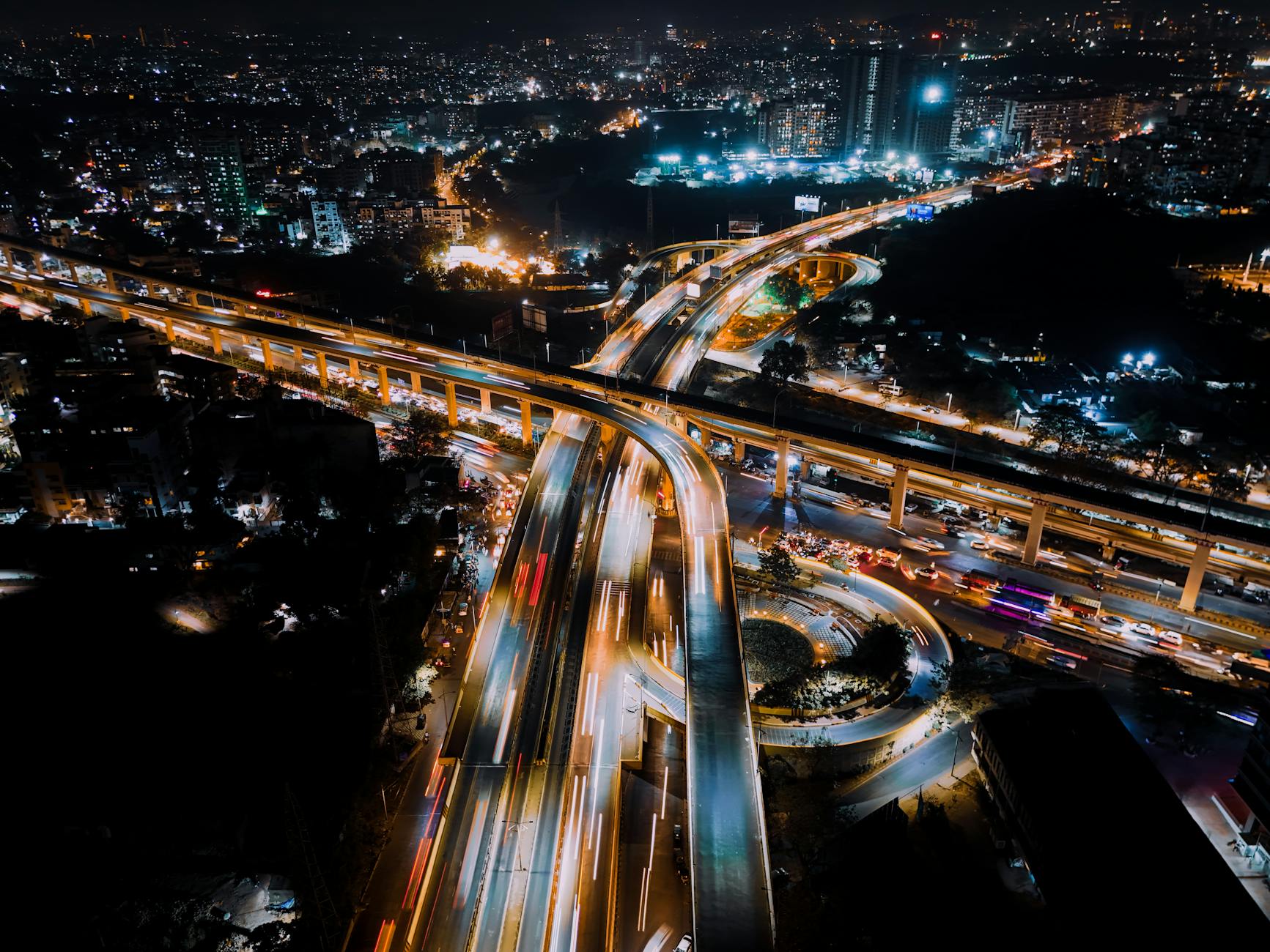 A cityscape at night, illuminated by clean, sustainable energy sources, with visible smart grid infrastructure and subtle holographic energy flow lines, conveying a sense of advanced, harmonious urban living. The aesthetic is aspirational and highly detailed.