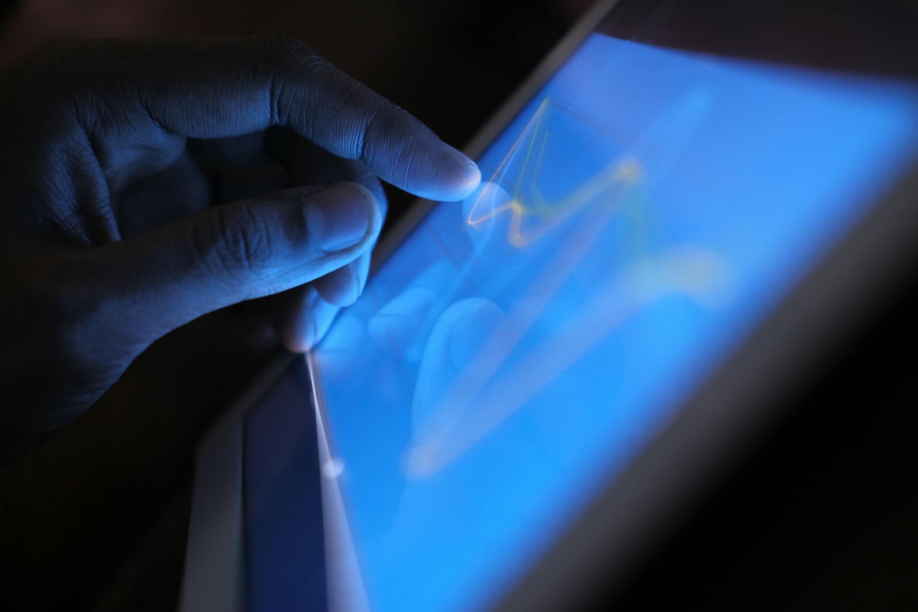 A close-up of a human hand interacting with a holographic interface, managing energy consumption and generation in a smart home setting, emphasizing user control and intuitive technology. The focus is on human-tech synergy.