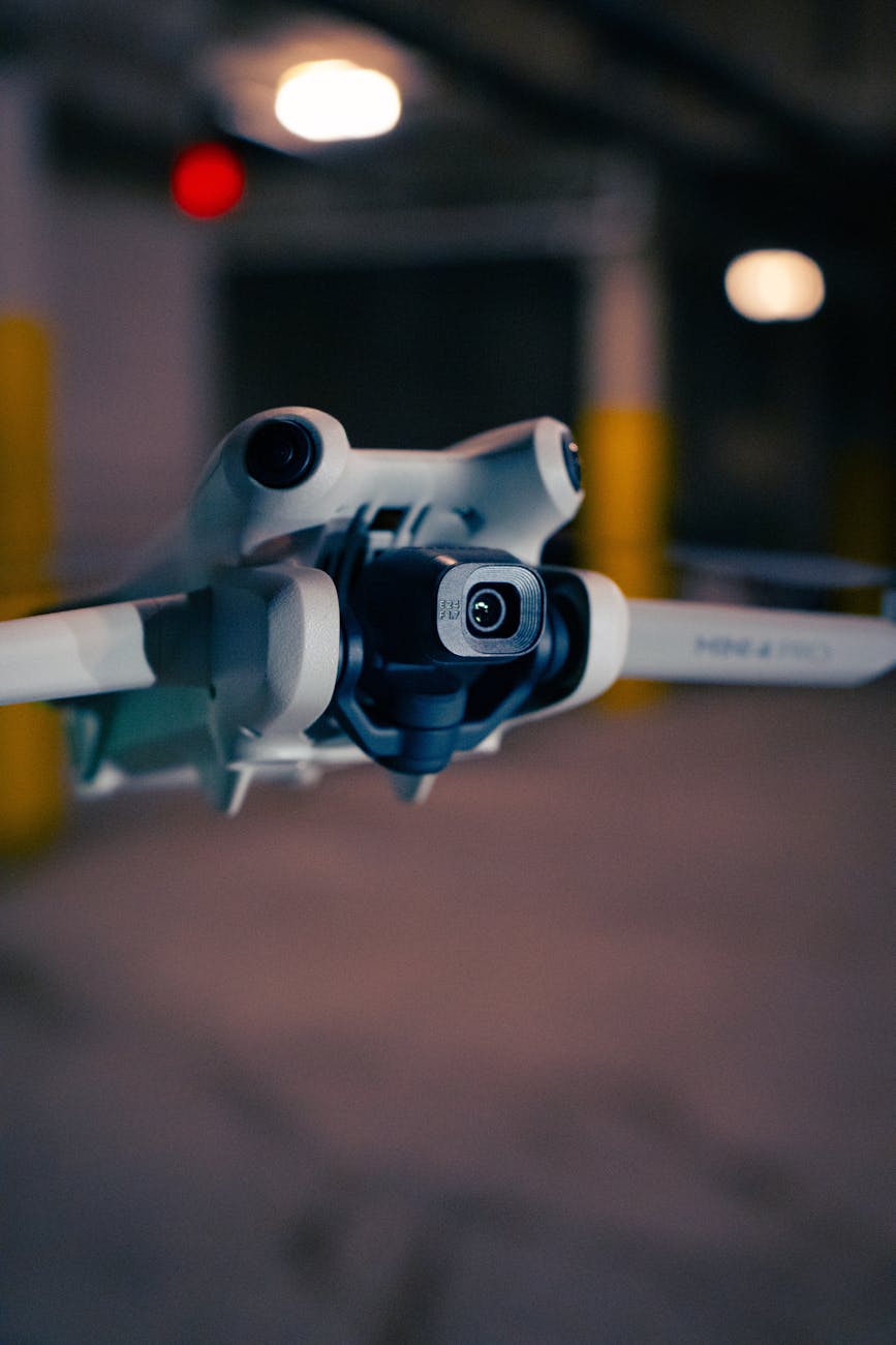 A close-up, stylized shot of an AMR's sensor array, highlighting LiDAR, cameras, and ultrasonic sensors. The background is blurred, showing a factory floor or warehouse, emphasizing the robot's perception capabilities. The image should have a high-tech, slightly abstract feel, perhaps with data points or light trails emanating from the sensors.