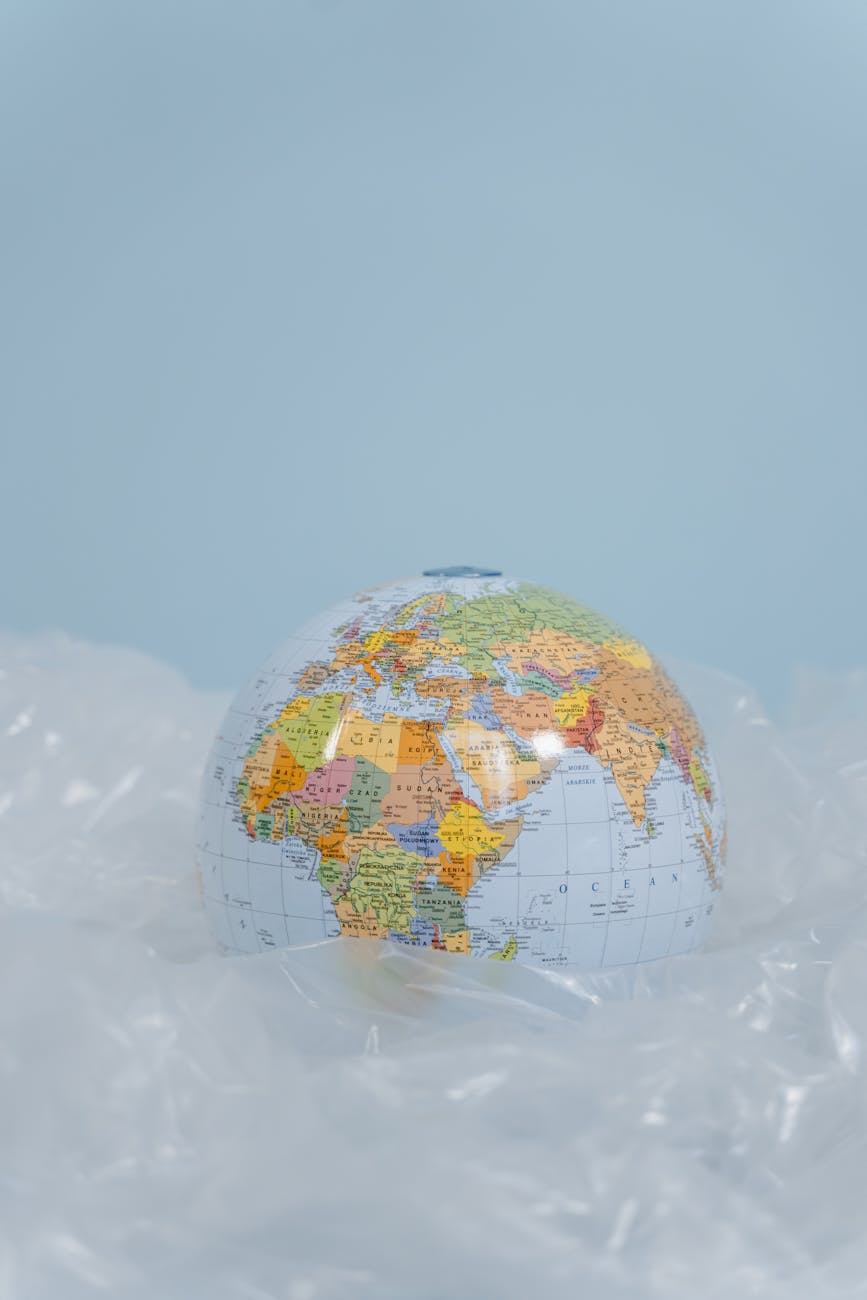 A sophisticated, abstract global map overlaid with interconnected nodes and lines, symbolizing international collaboration, policy frameworks, and investment flows in sustainable aviation. Different regions are highlighted to show varying levels of engagement.