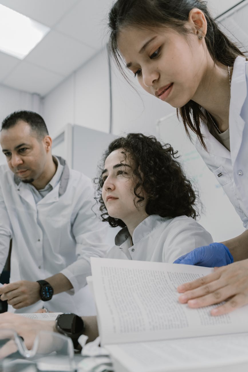 A diverse group of scientists and medical professionals collaborating around a futuristic holographic interface displaying organ regeneration data.