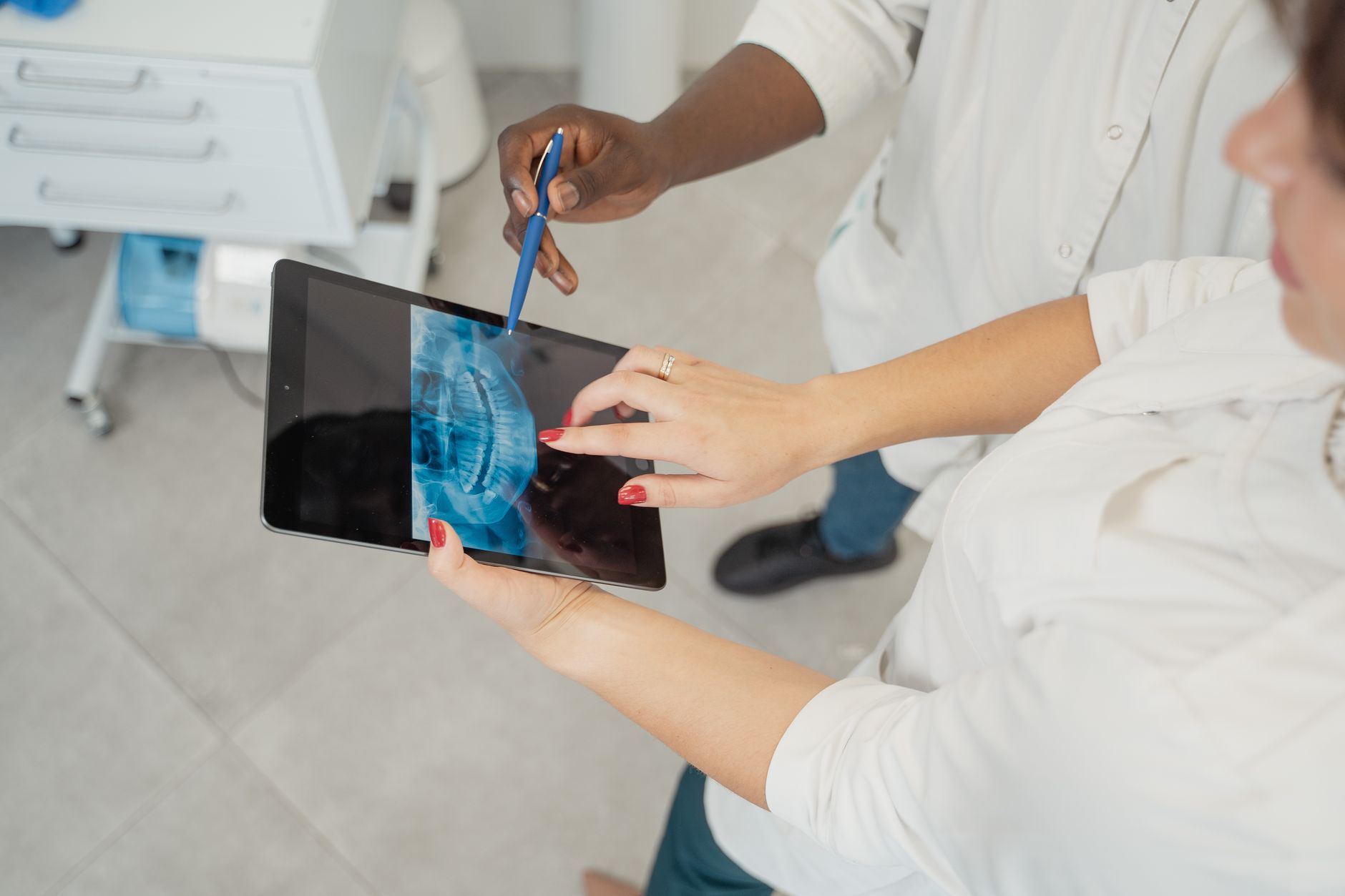 A medical professional interacting with a holographic display showing a patient's digital twin, highlighting areas of potential disease progression.