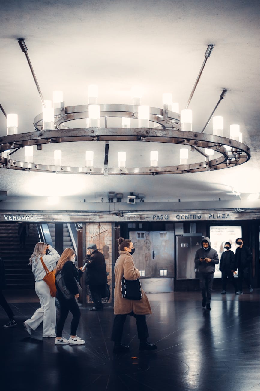 A diverse group of passengers disembarking from an eVTOL at a bustling vertiport, seamlessly transitioning to a waiting autonomous ground vehicle.